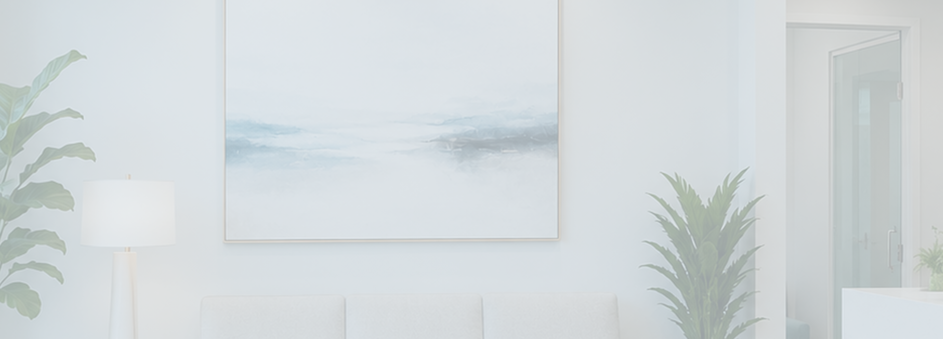 A bright dental waiting room featuring a white couch, a floor lamp, green plants, and an abstract painting on the wall.